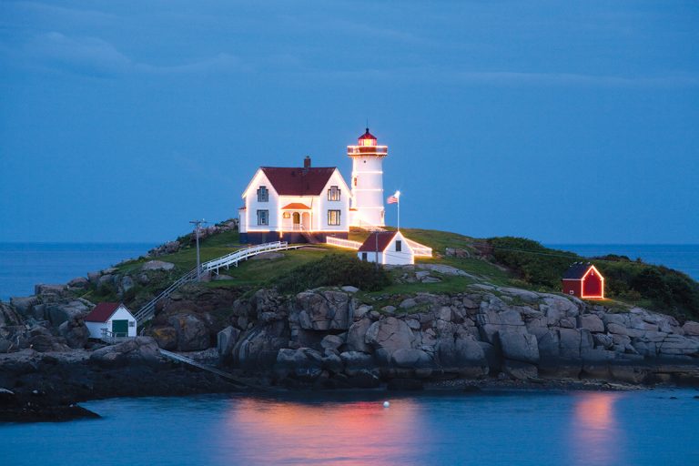 Nubble Lighthouse lit up during the summer.